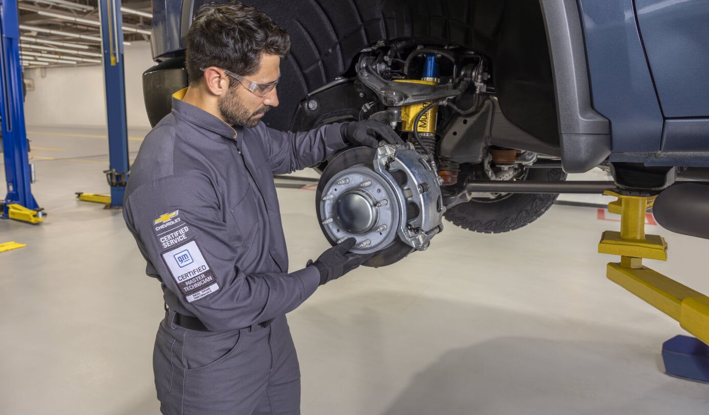 Chevrolet GM Certified Master Technician working inside a modern dealership service bay.